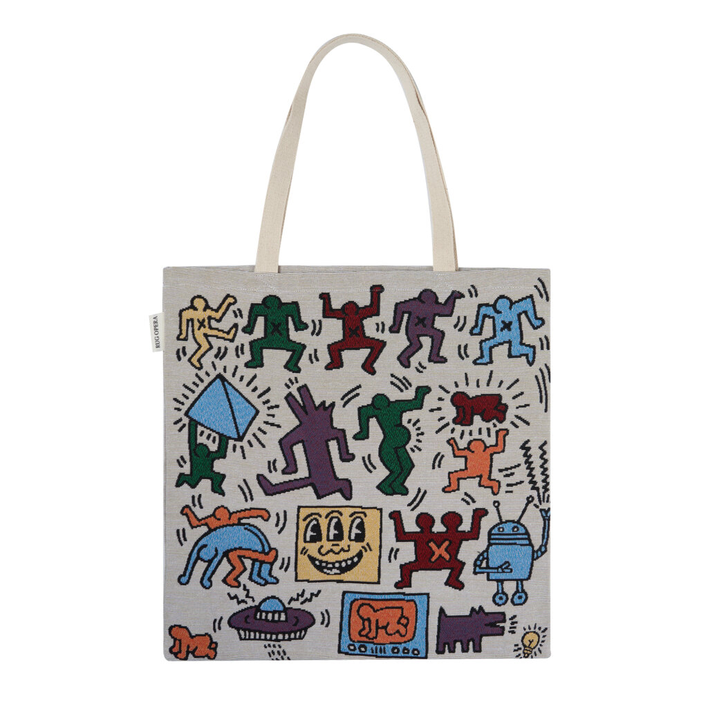 The Haring Kinetic Tote by Rug Opera, an artistic woven cotton bag featuring iconic Keith Haring energetic motifs in a black and white tapestry weave.